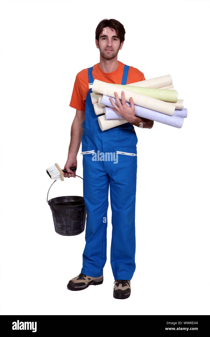 Tradesman holding wallpaper rolls Stock Photo