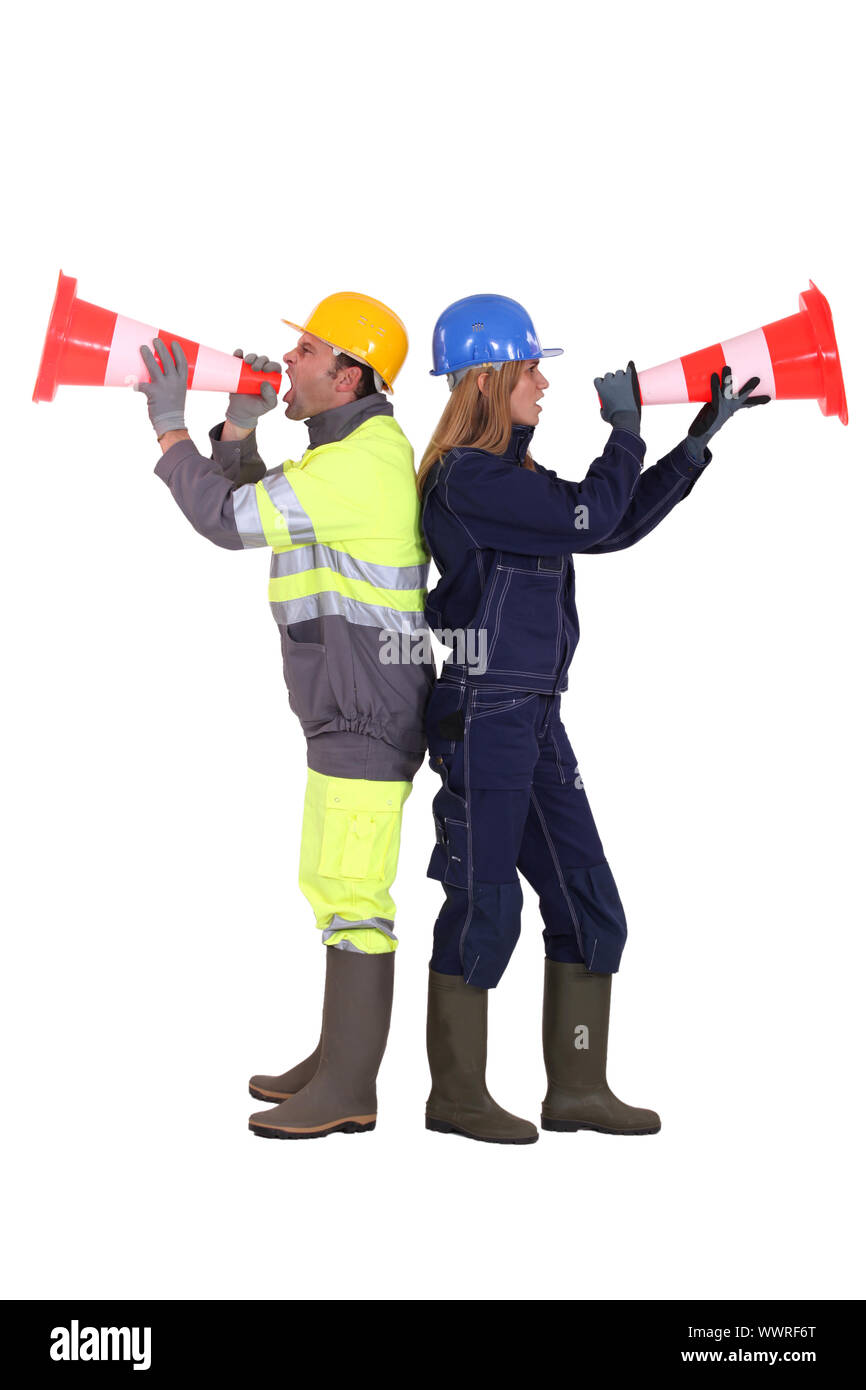 Labourers shouting in traffic cones Stock Photo