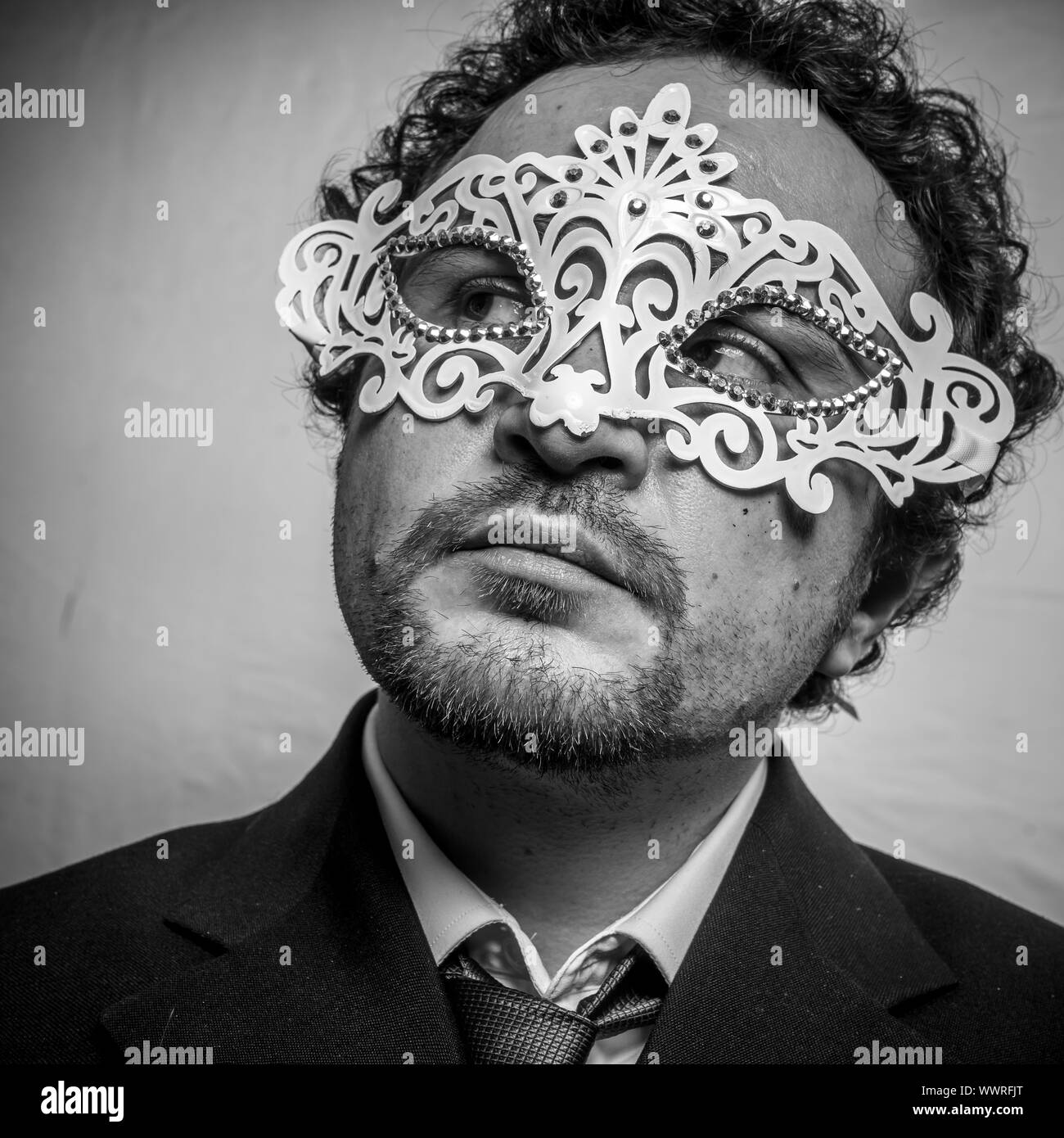 Fraud, Sensual and mysterious businessman with white venetian mask ...