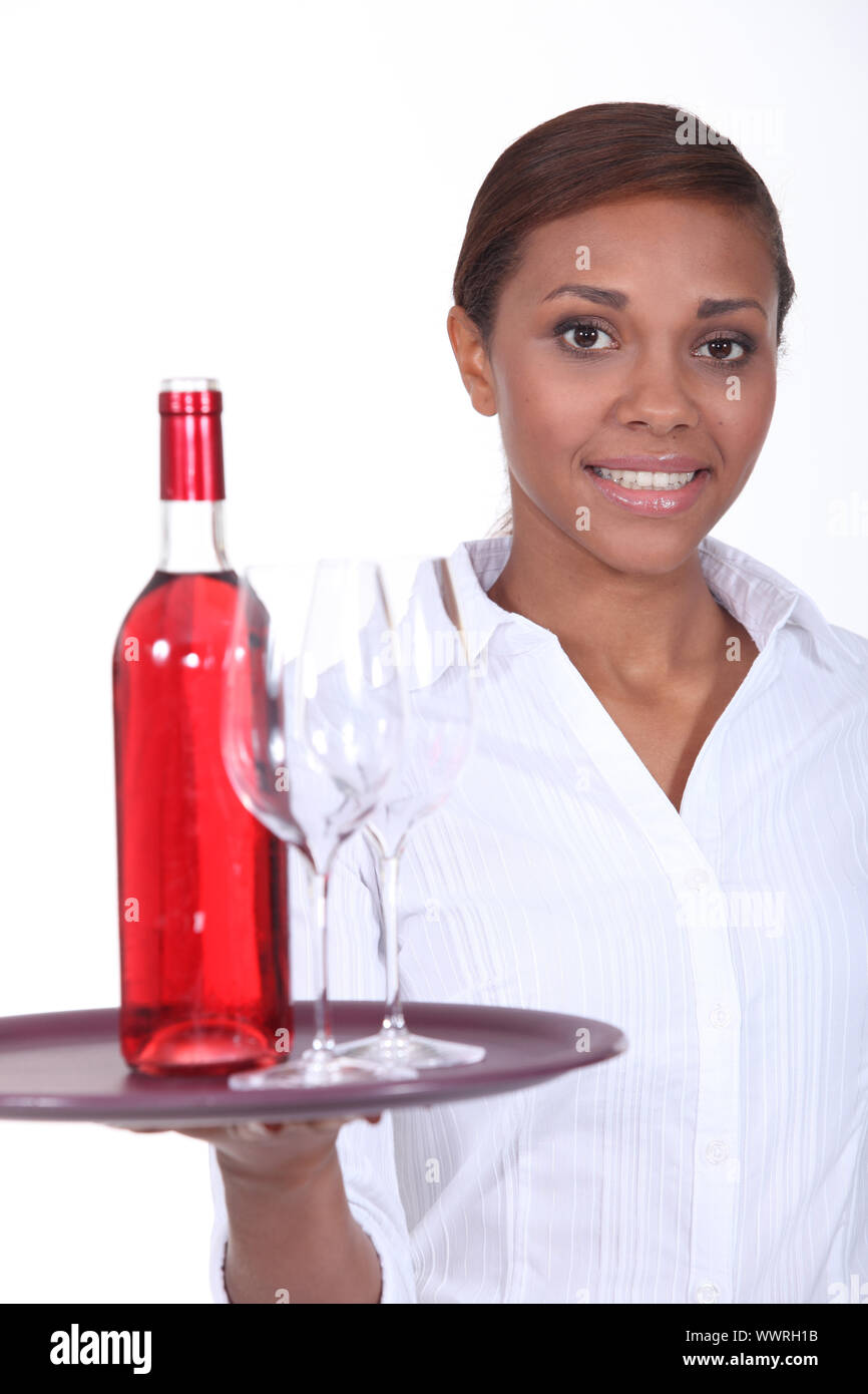 Waitress with a bottle of rose wine Stock Photo Alamy