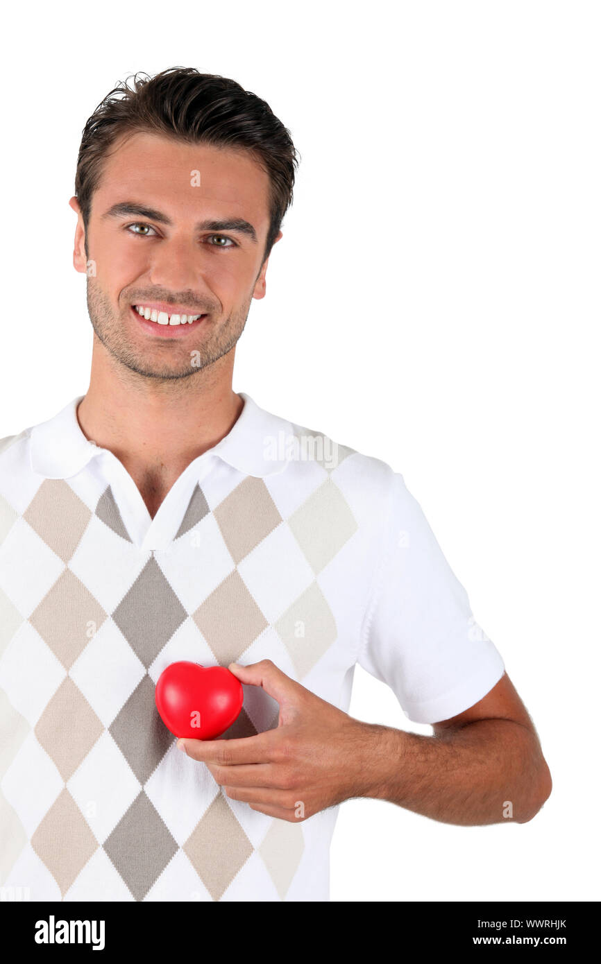 Young man holding red heart Stock Photo - Alamy