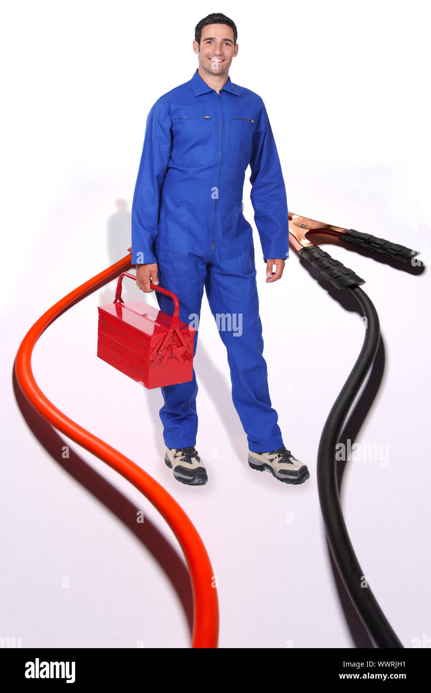 Tradesman surrounded by jumper cables Stock Photo
