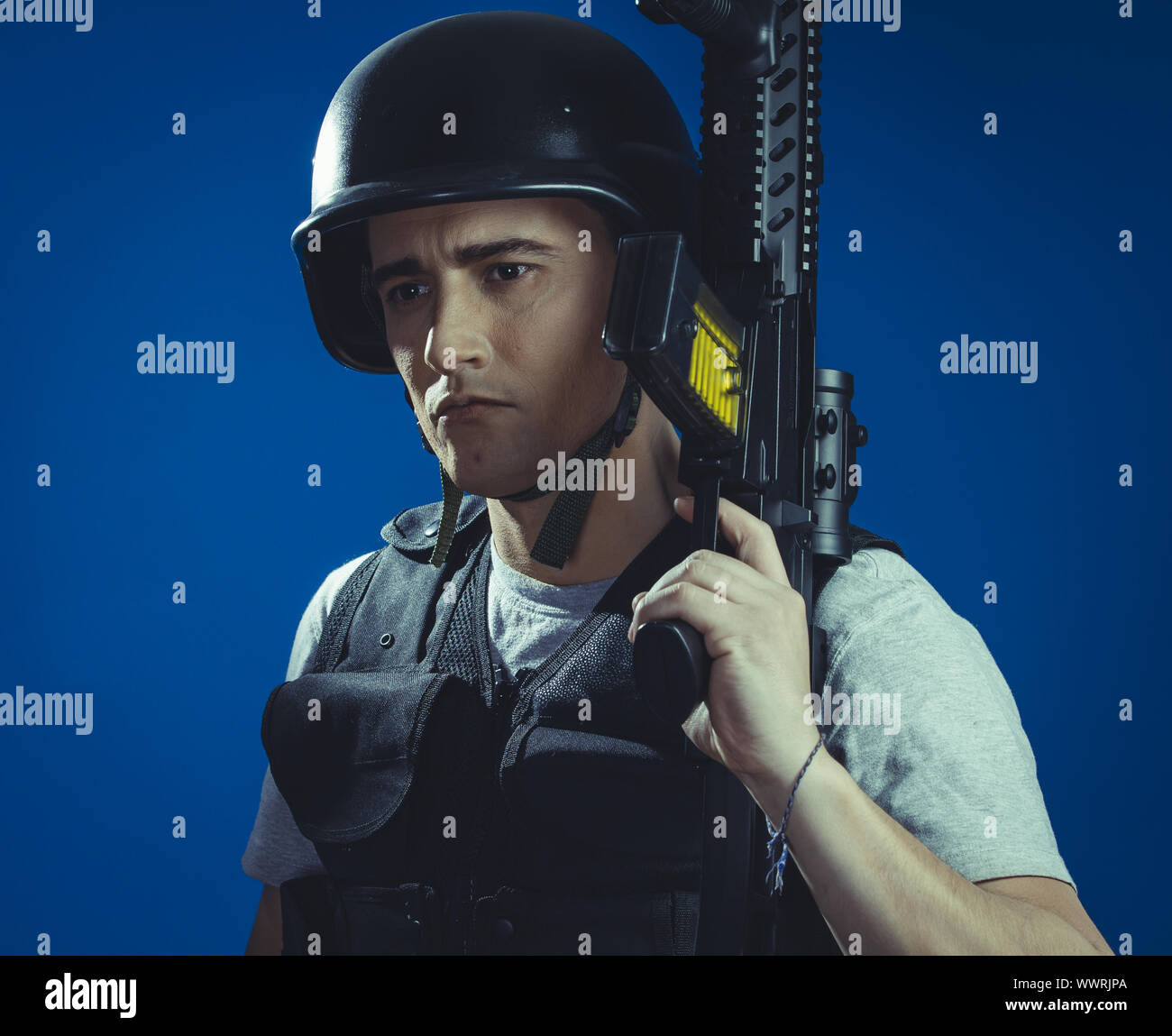 airsoft sport player wearing protective helmet aiming pistol ,black