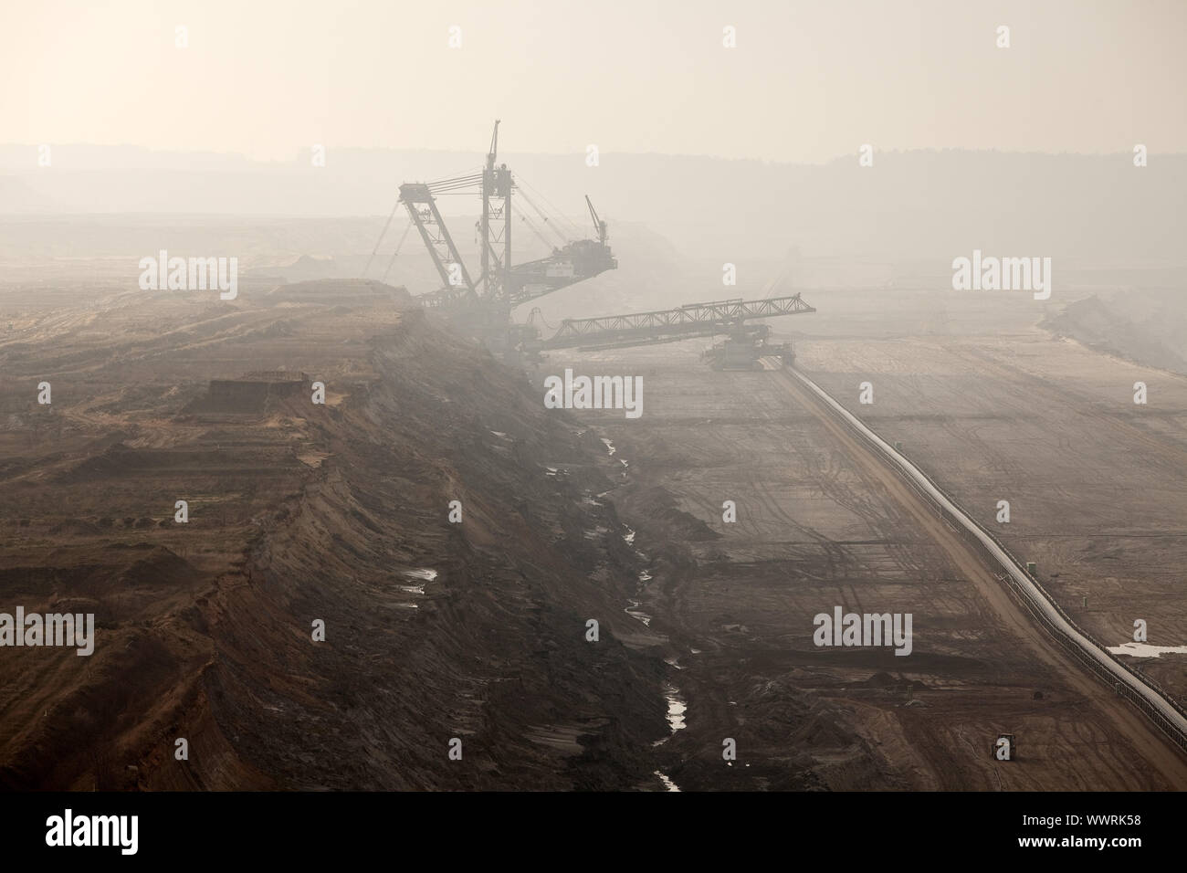 brown coal surface mining Hambach with spreader and tripper car in the mist, Elsdorf, Germany Stock Photo