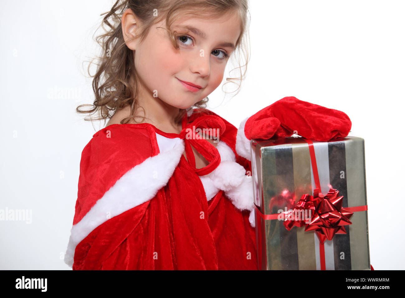 Little girl holding Christmas present Stock Photo - Alamy
