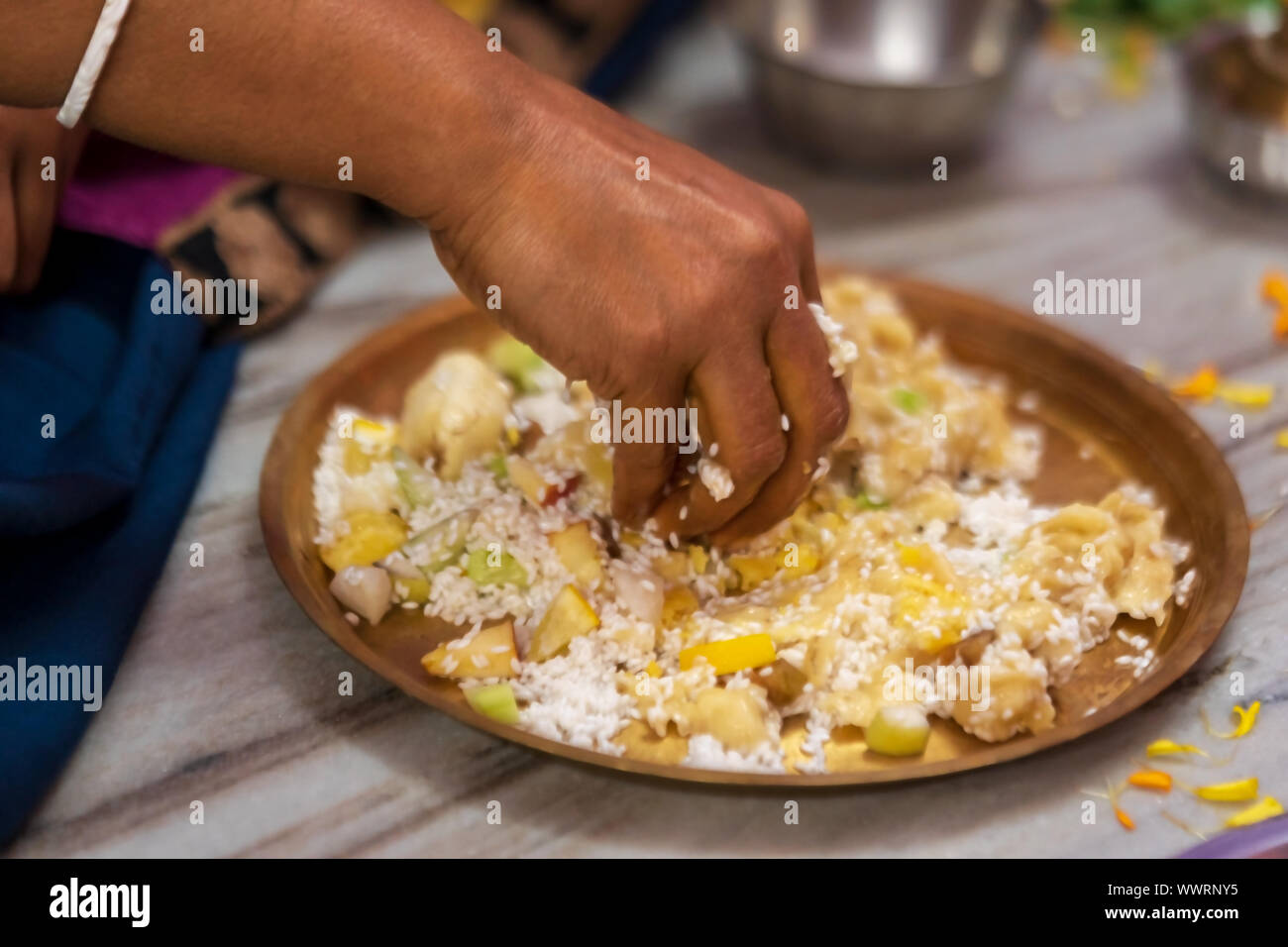 Indian housewife preparing naibedya or prasad for durga, kali puja. Background image for hindu culture. Stock Photo