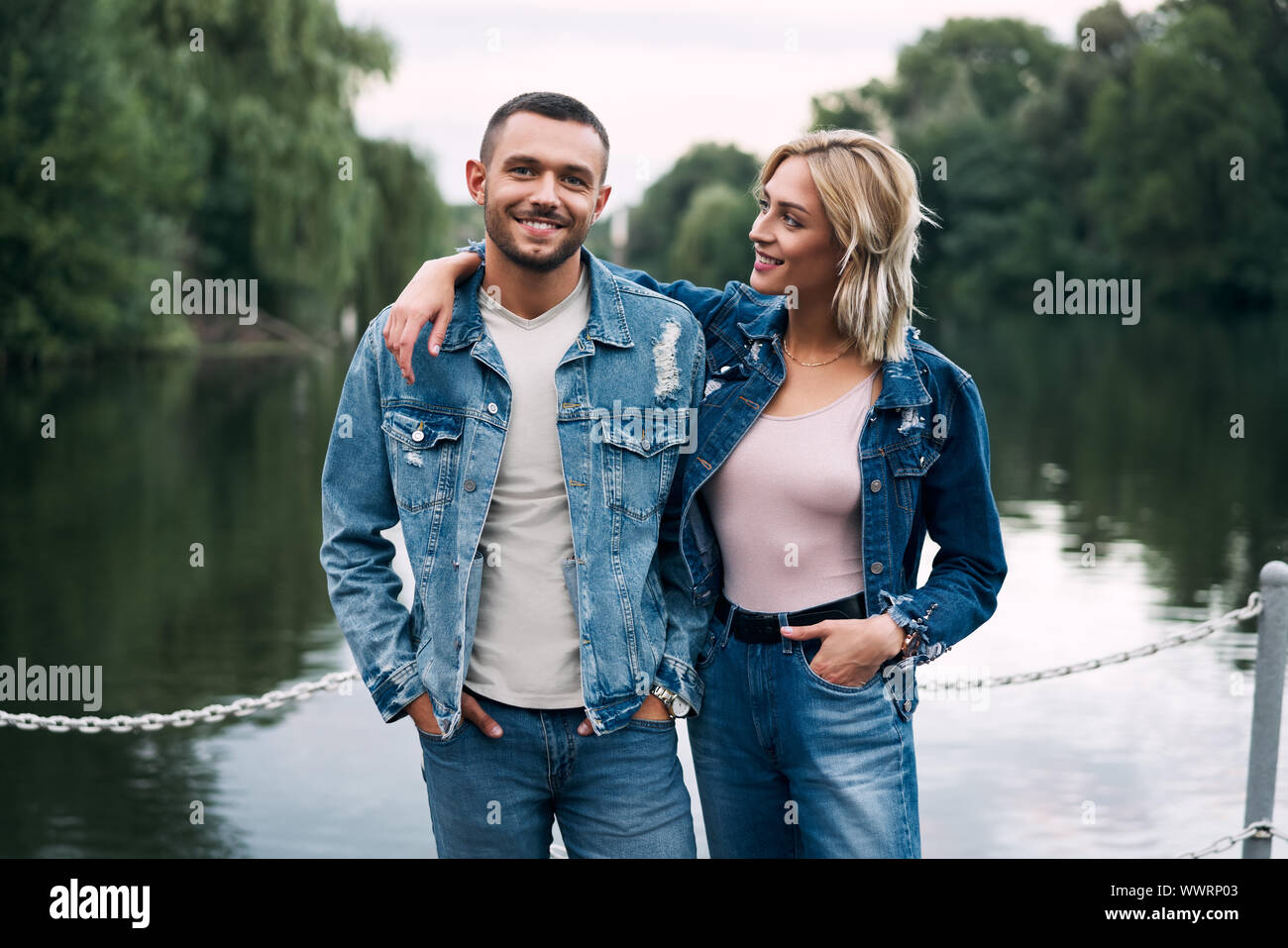 Young happy couple in love posing near river. Relationship, travel concept Stock Photo
