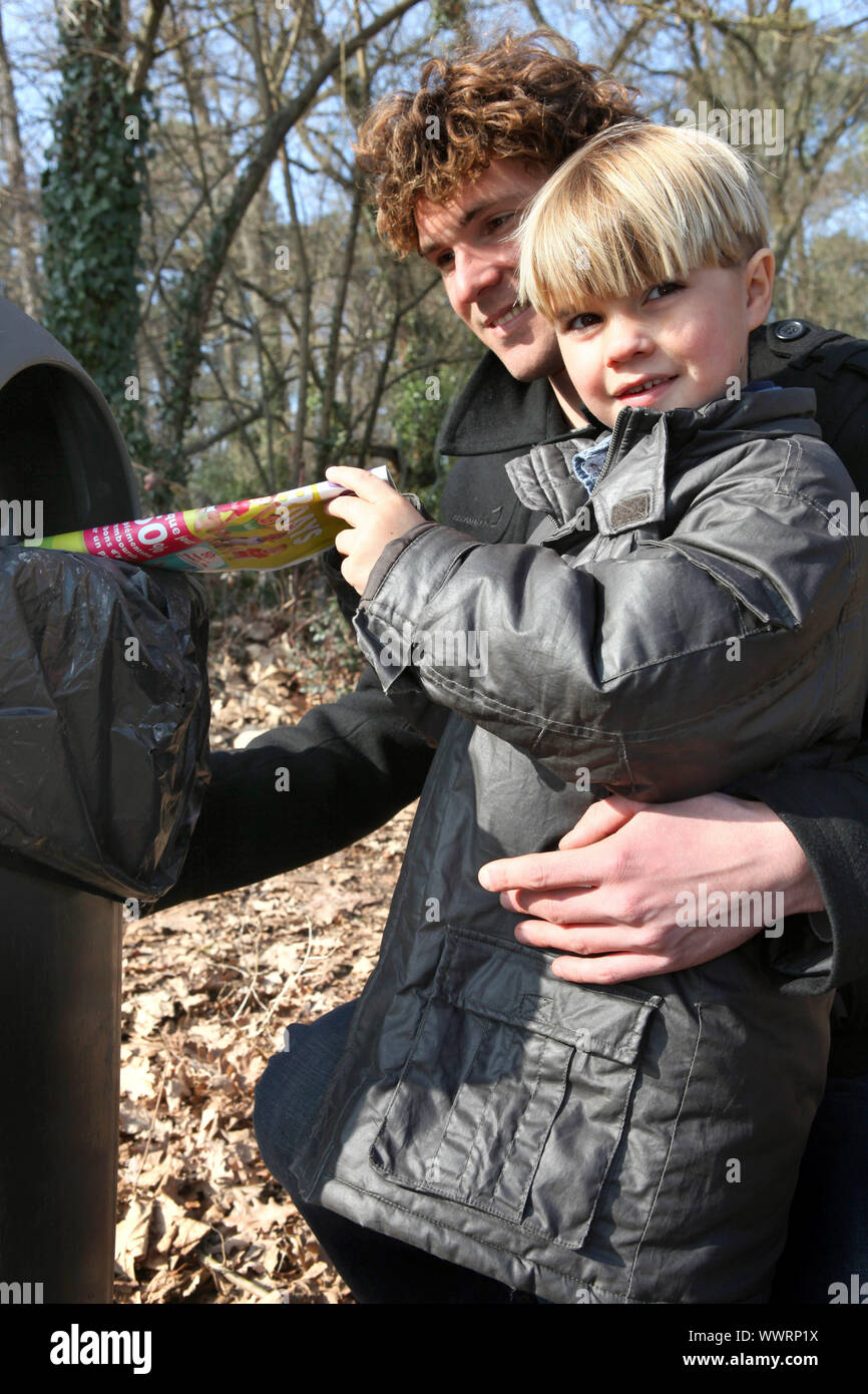 Father and son recycling flyers Stock Photo - Alamy