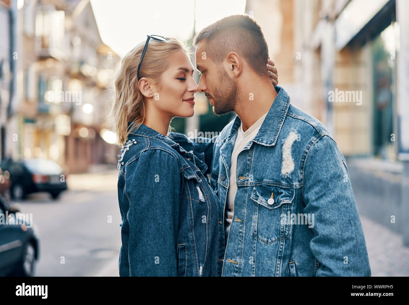 Young loving couple kissing and enjoying the company of each other outdoors. Love, passion, dating concept Stock Photo