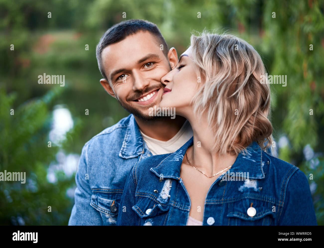 Romantic young couple relax on nature. Love, hugs, happy relationship concept Stock Photo