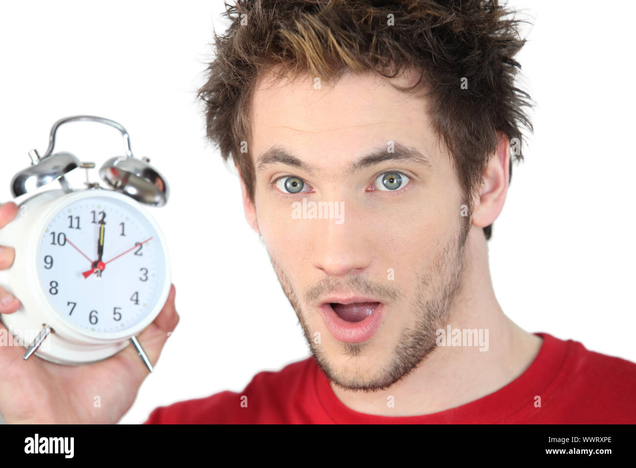 Shocked man with alarm clock Stock Photo Alamy