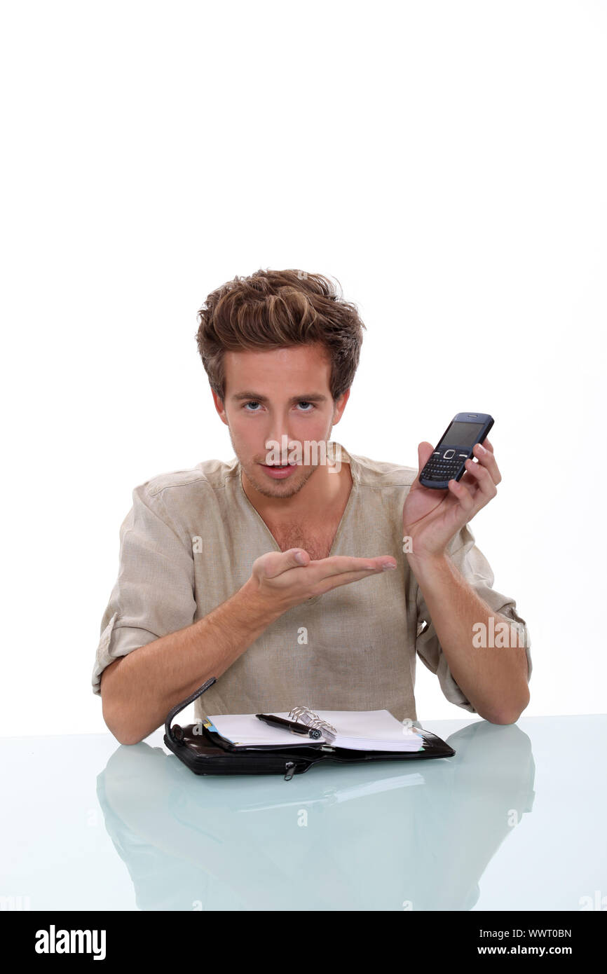 Man with a personal organizer demonstrating cellphone Stock Photo