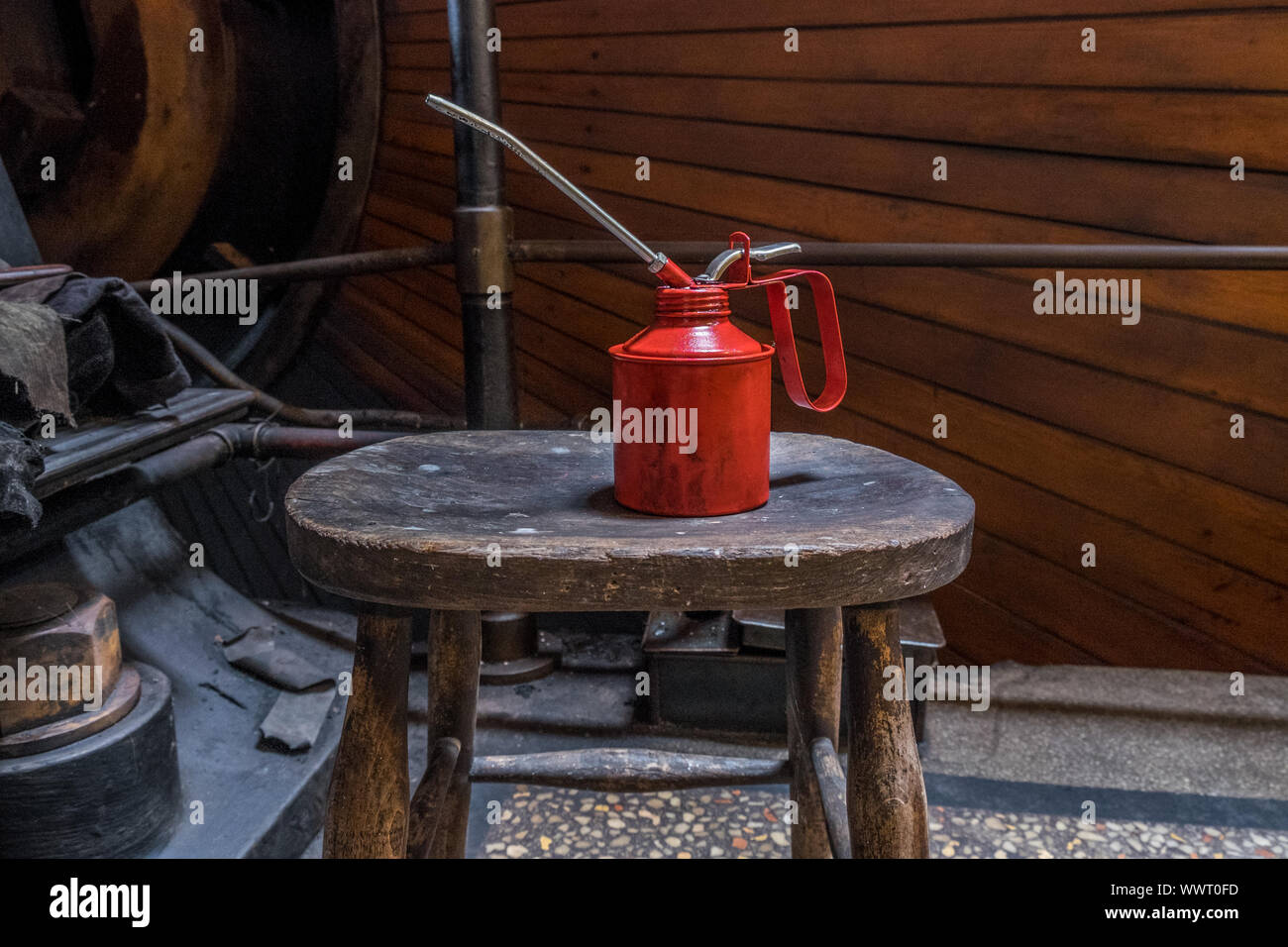 Red oil can in an engineering workshop. Stock Photo