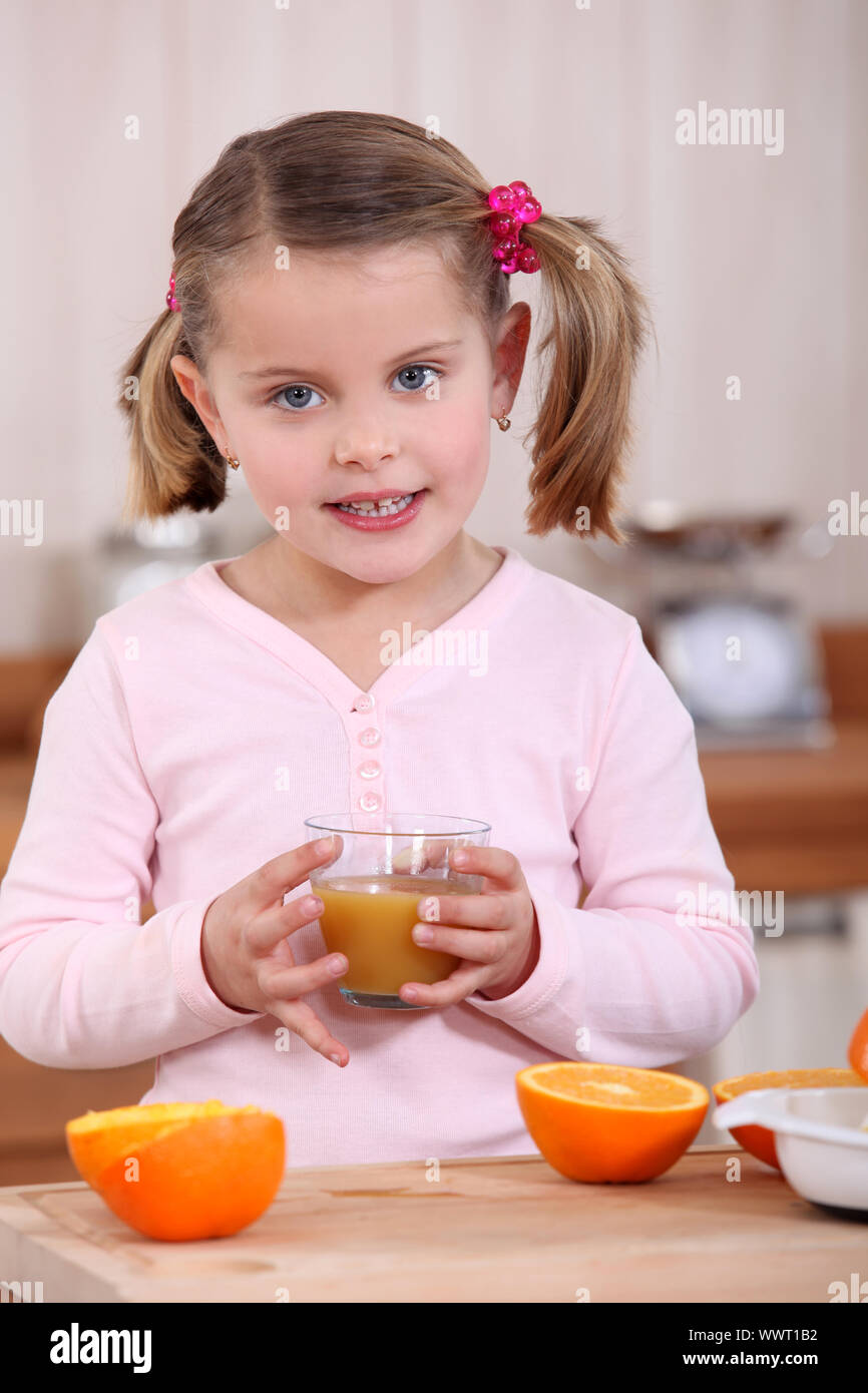 Girl drinking orange juice Stock Photo