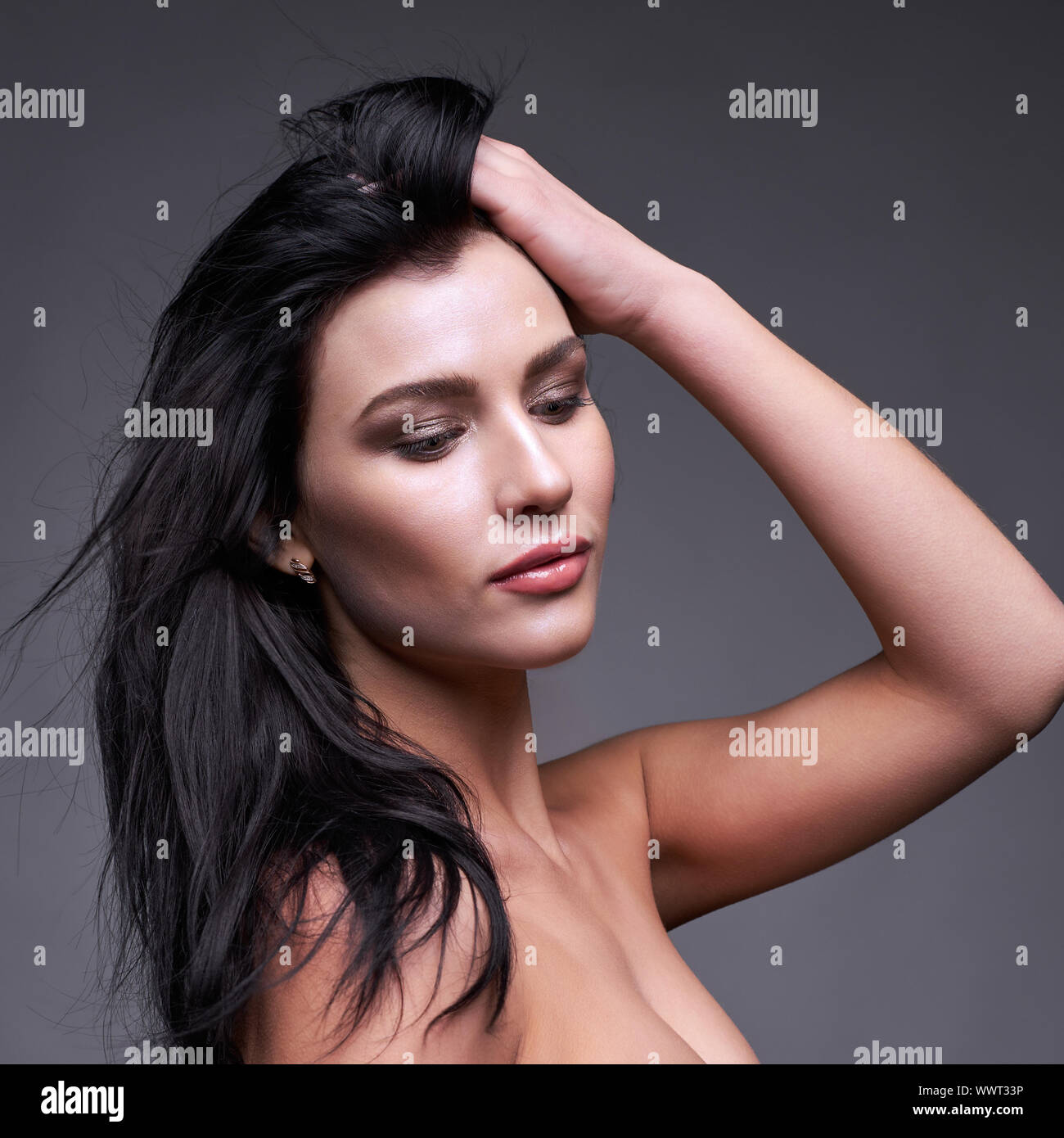 Portrait of a young brunette woman with long black streaming hair Stock Photo