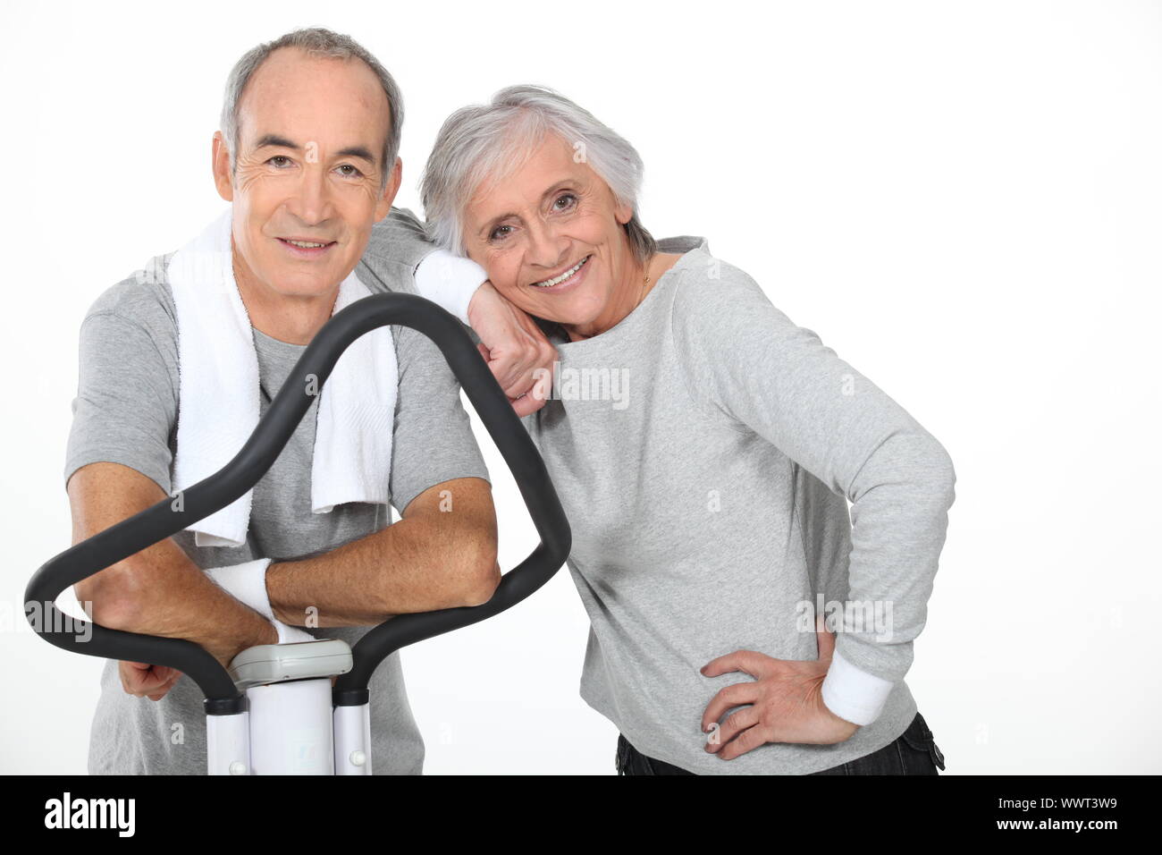 Senior couple using gym equipment Stock Photo