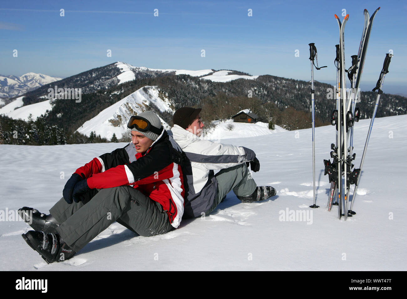 Skiers sitting in the snow Stock Photo