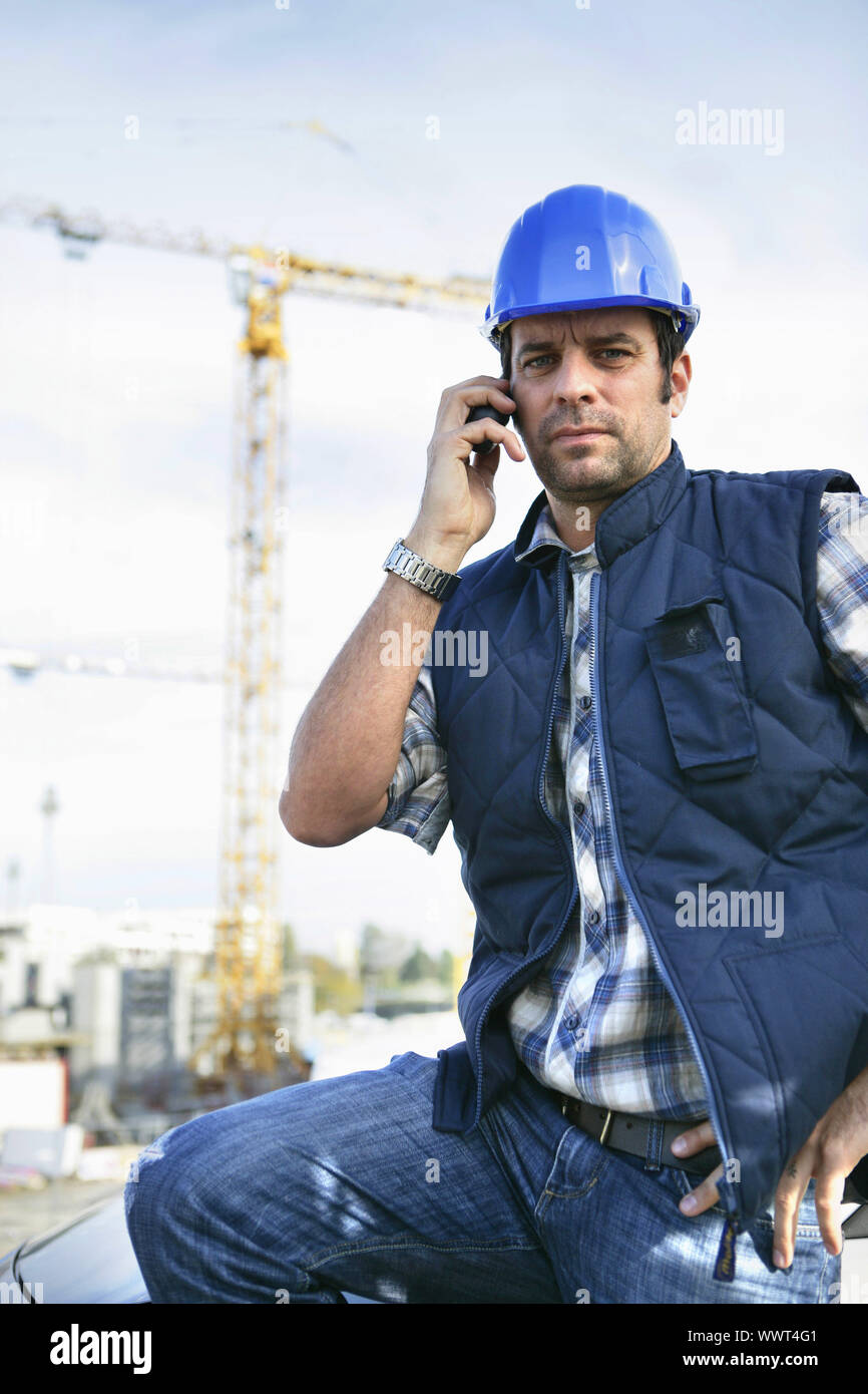 foreman in construction site making a call Stock Photo