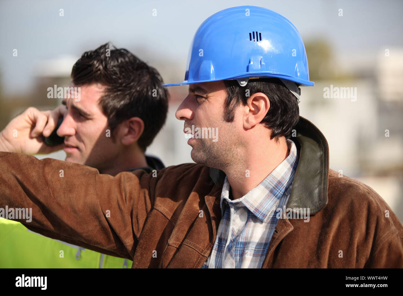 construction supervisor and assistant observing Stock Photo
