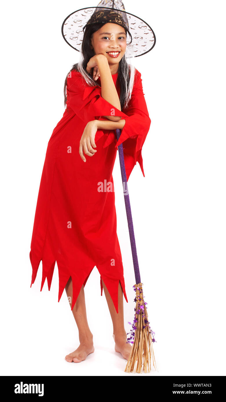 Girl In A Halloween Witch Costume Leaning On Her Broomstick Stock Photo