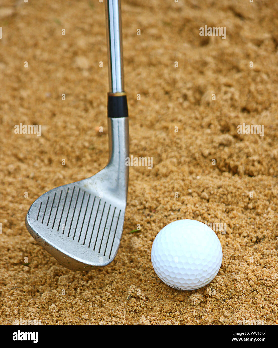 Hitting A Golf Ball Out Of A Bunker Using A Sand Wedge Stock Photo