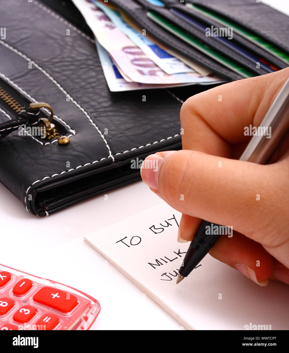 Woman Making A List Of Things To Buy In A Shop Stock Photo Alamy