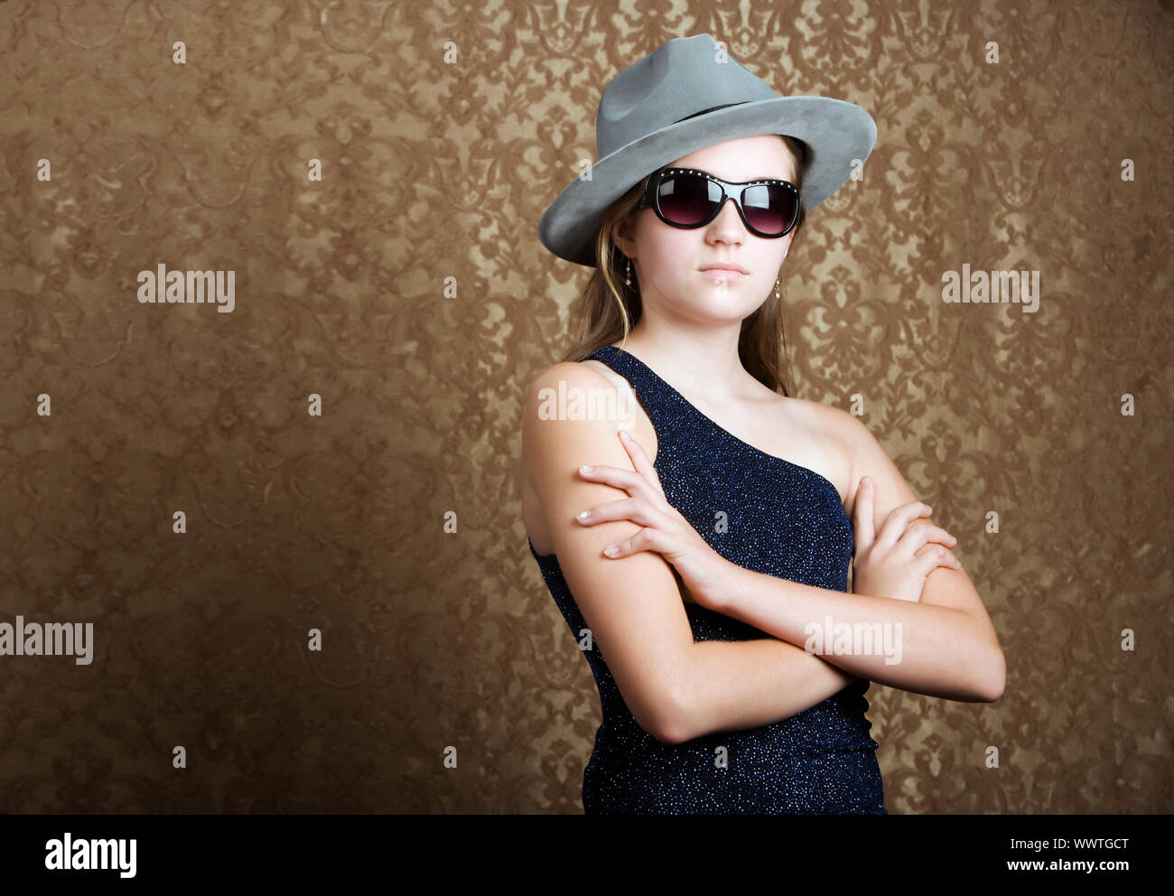 Young girl wearing a fedora and dark sunglasses Stock Photo Alamy