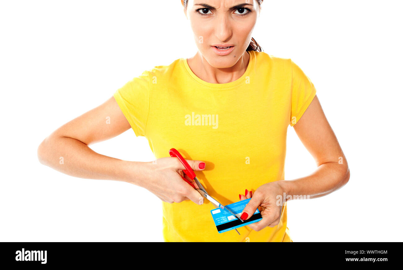 Annoyed teen customer destroying credit card. Isolated against white background Stock Photo - Alamy