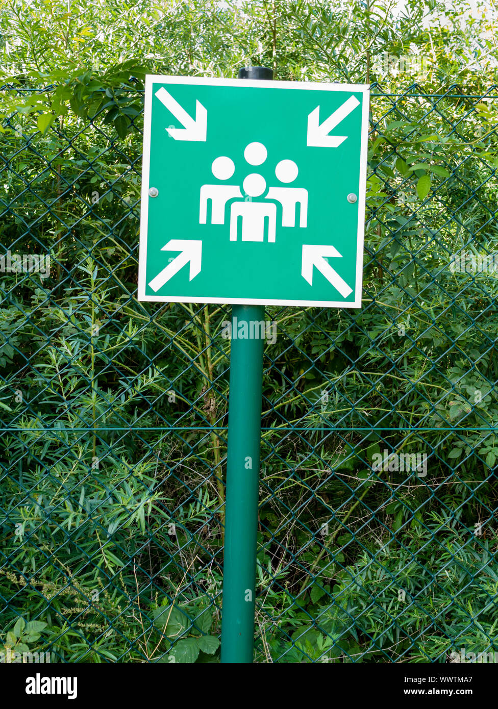 Sign with pictogram symbolizing an assembly station for people in case of an emergency or catastrophe. Stock Photo