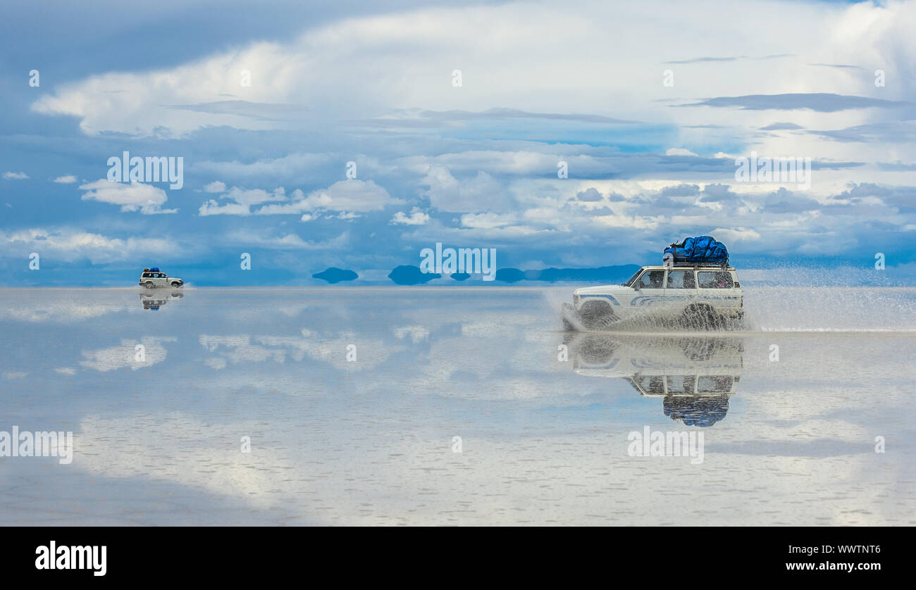 Off-road vehicles driving in Salar de Uyuni, Bolivia, the world's largest salt flat Stock Photo