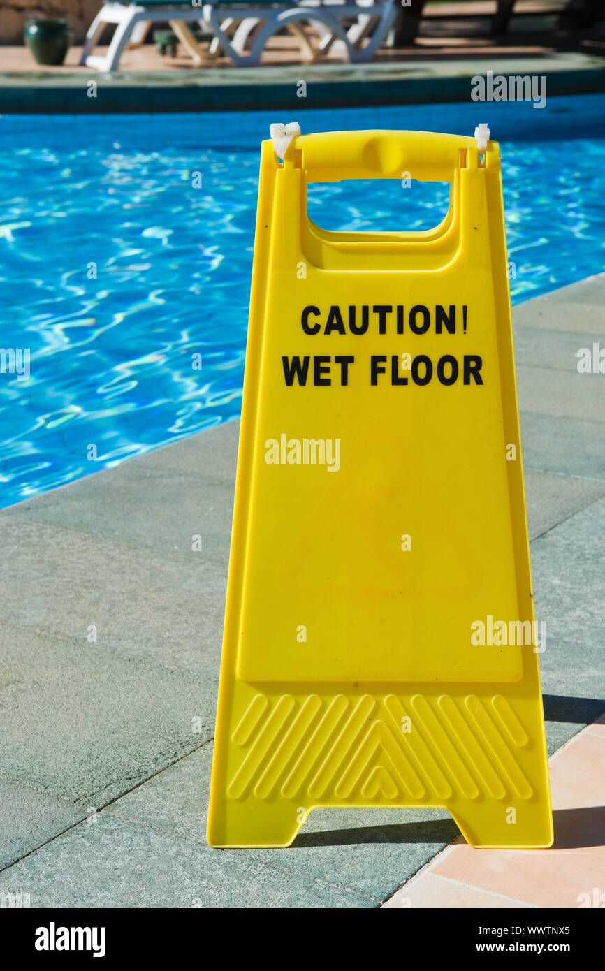 Sign with caution wet floor near the swimming pool Stock Photo Alamy