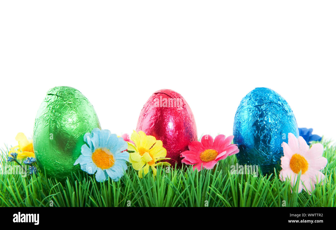Green artificial grass with flowers and easter eggs Stock Photo - Alamy