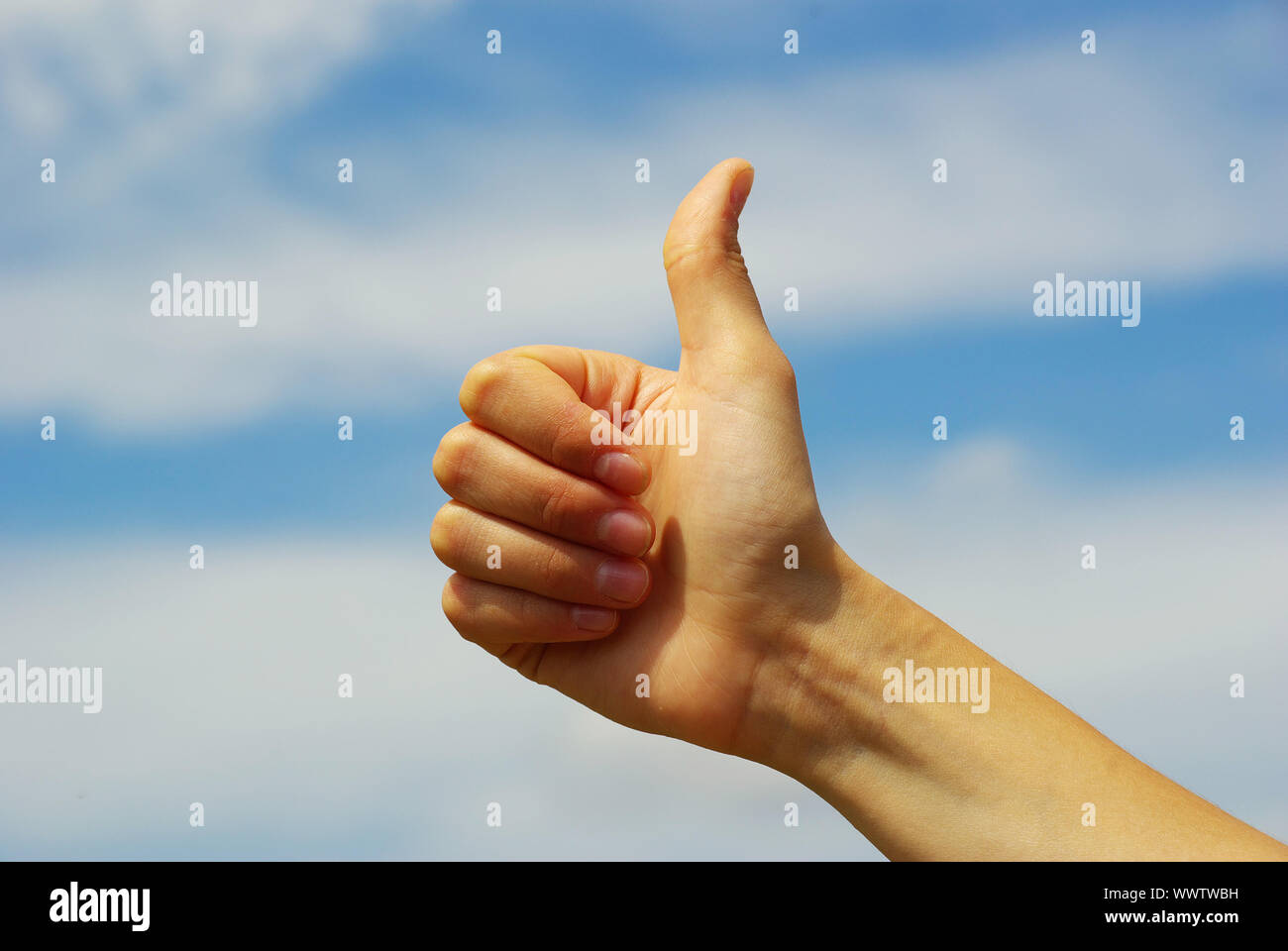 Womans hand with thumb up ok signal Stock Photo - Alamy