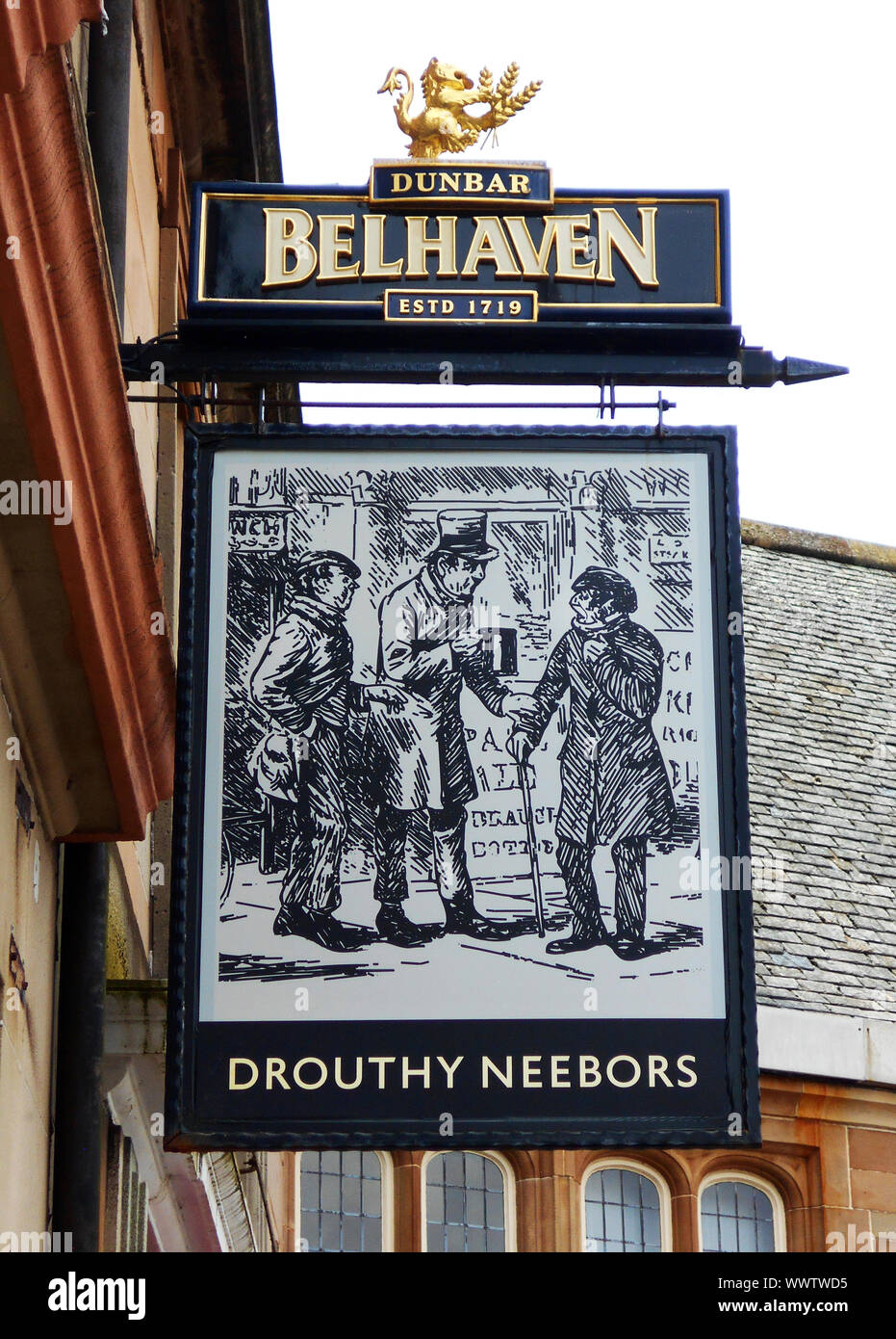 The pub sign outside the Drouthy Neebors public house in the sea side town of Largs on the Firth of Clyde, Scotland. The 2 words are taken from the second line of the poem by Robert Burns; Tam o' Shanter. Alan Wylie/ALAMY © Stock Photo