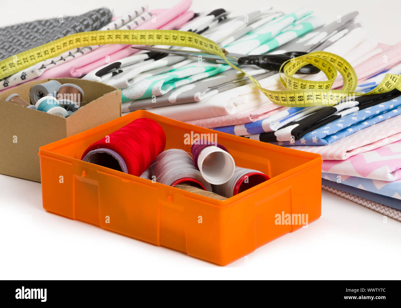 cotton fabric, tailor measurement tape and spools of cotton thread