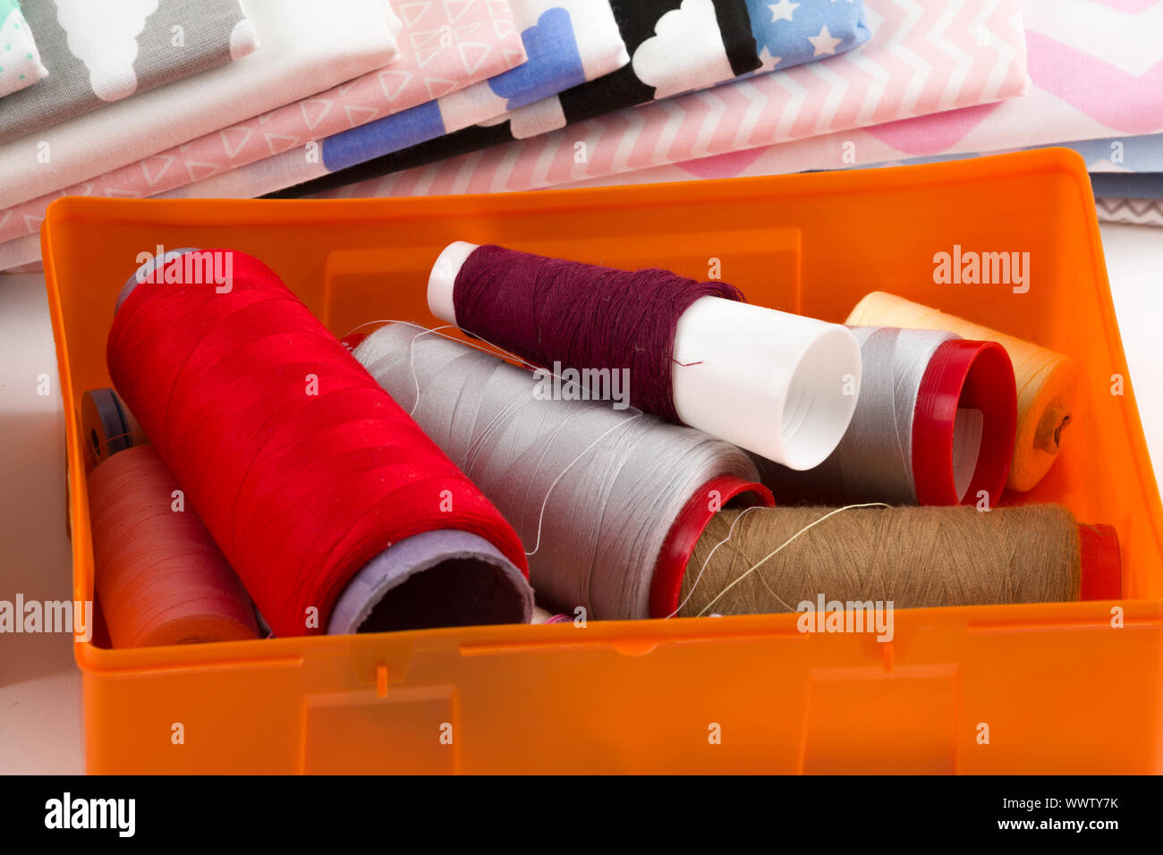 cotton fabric, tailor measurement tape and spools of cotton thread