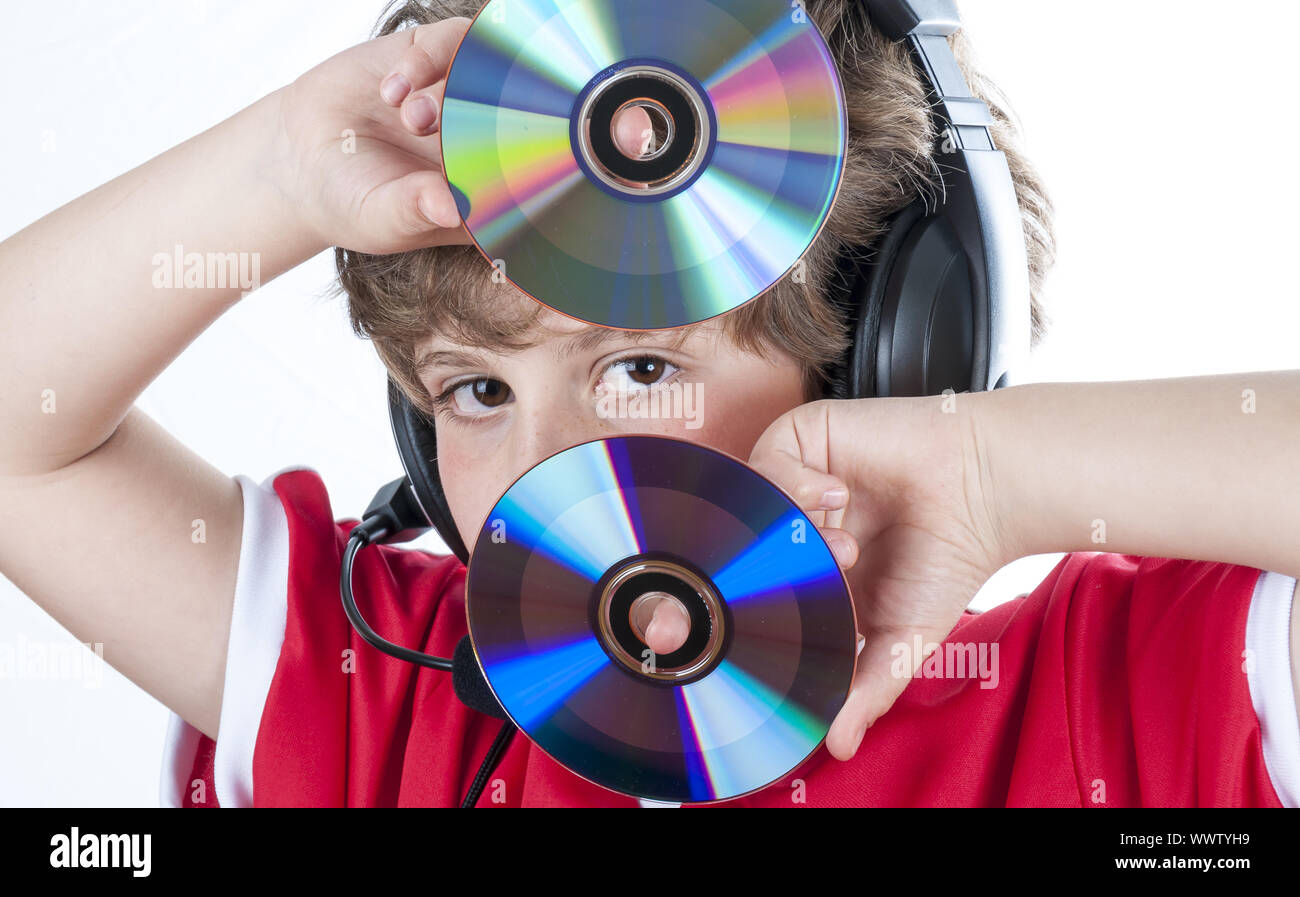 Blonde boy with music helmet on his head and musical records or cds in his hands Stock Photo