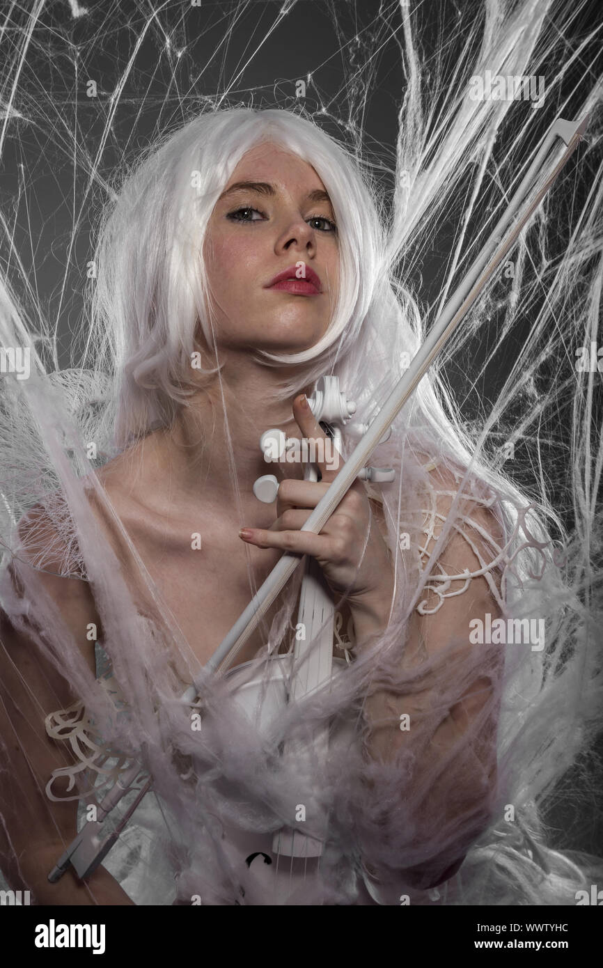 Violinist with white violin, beautiful girl with silver hair and lace clothes Stock Photo