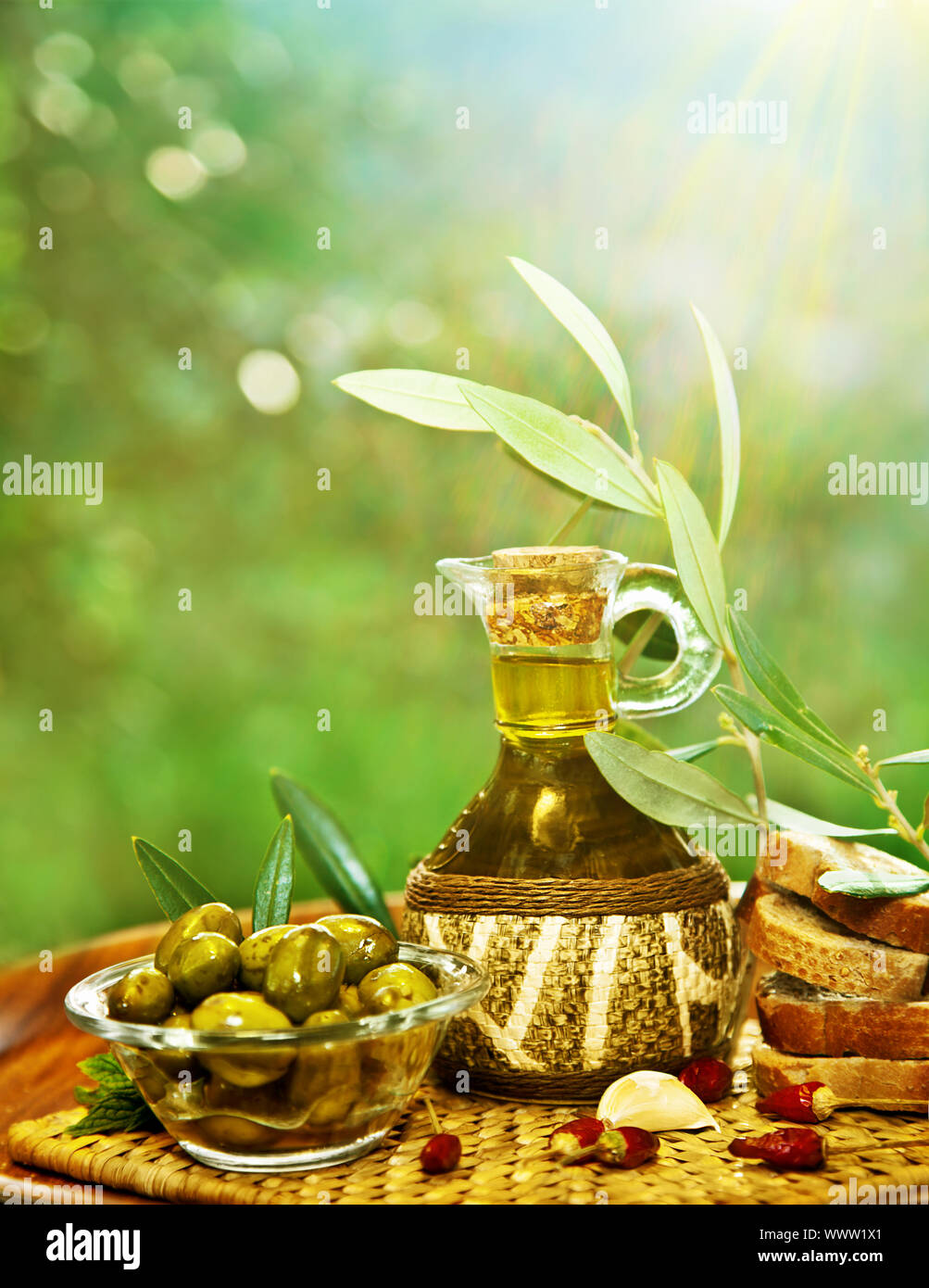 Olives in morning sunny garden, extra virgin olive oil still life