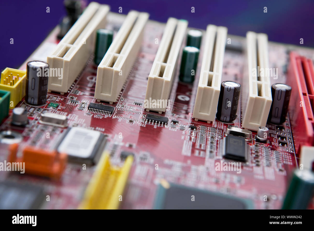 A detail image of a mother board with PCI slots. NOTE: Shallow depth of field is used to create an effective background image. Stock Photo