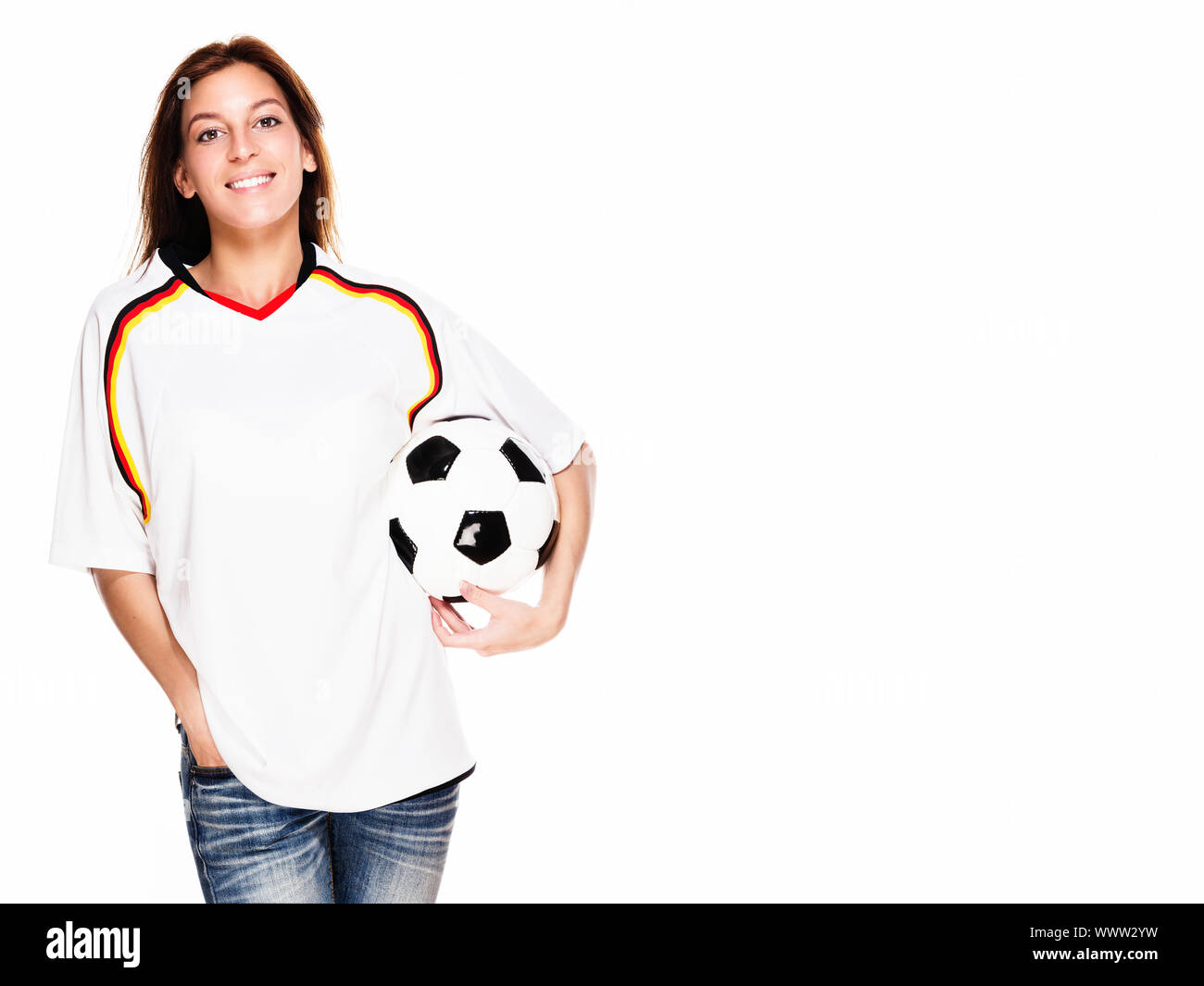 happy woman wearing football shirt holding football on white background Stock Photo