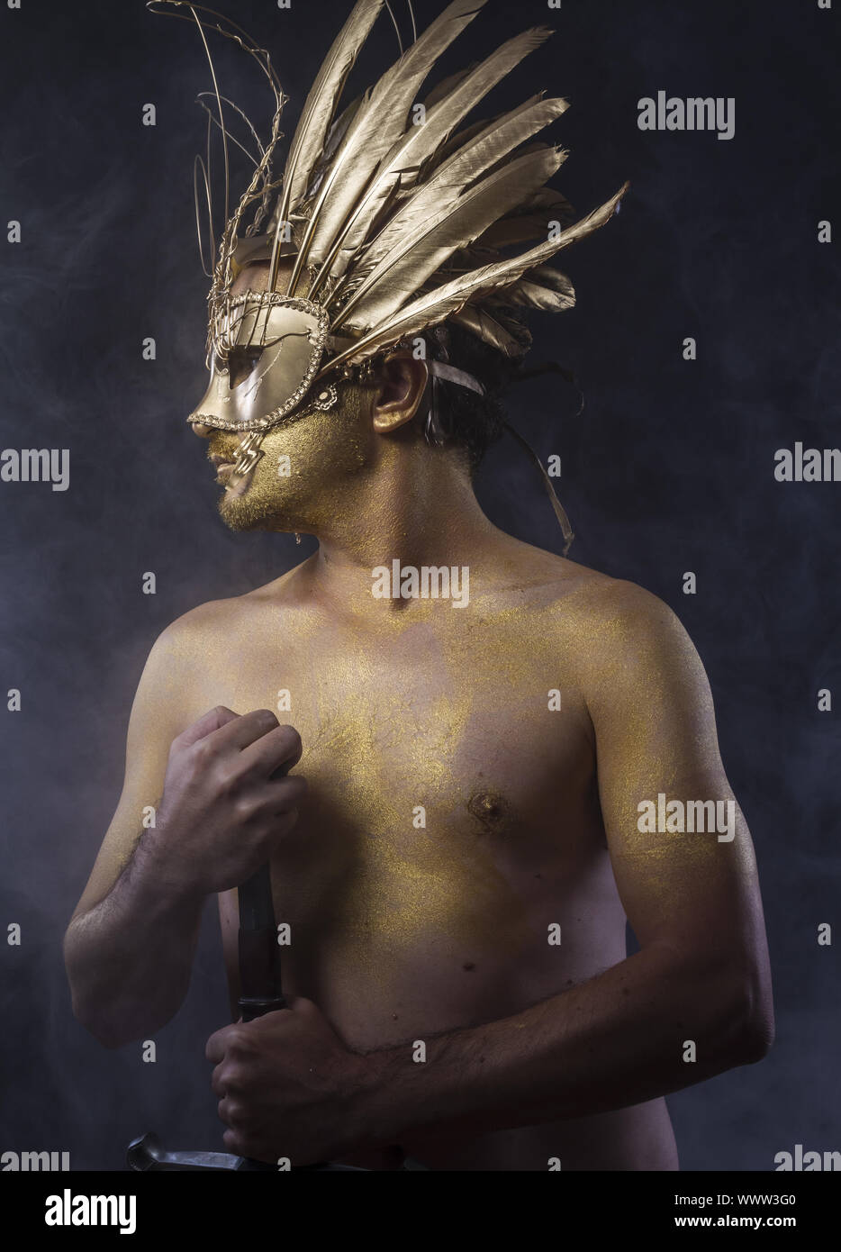 Fighter, Golden fantasy warrior, man with sword with gold skin covered Stock Photo