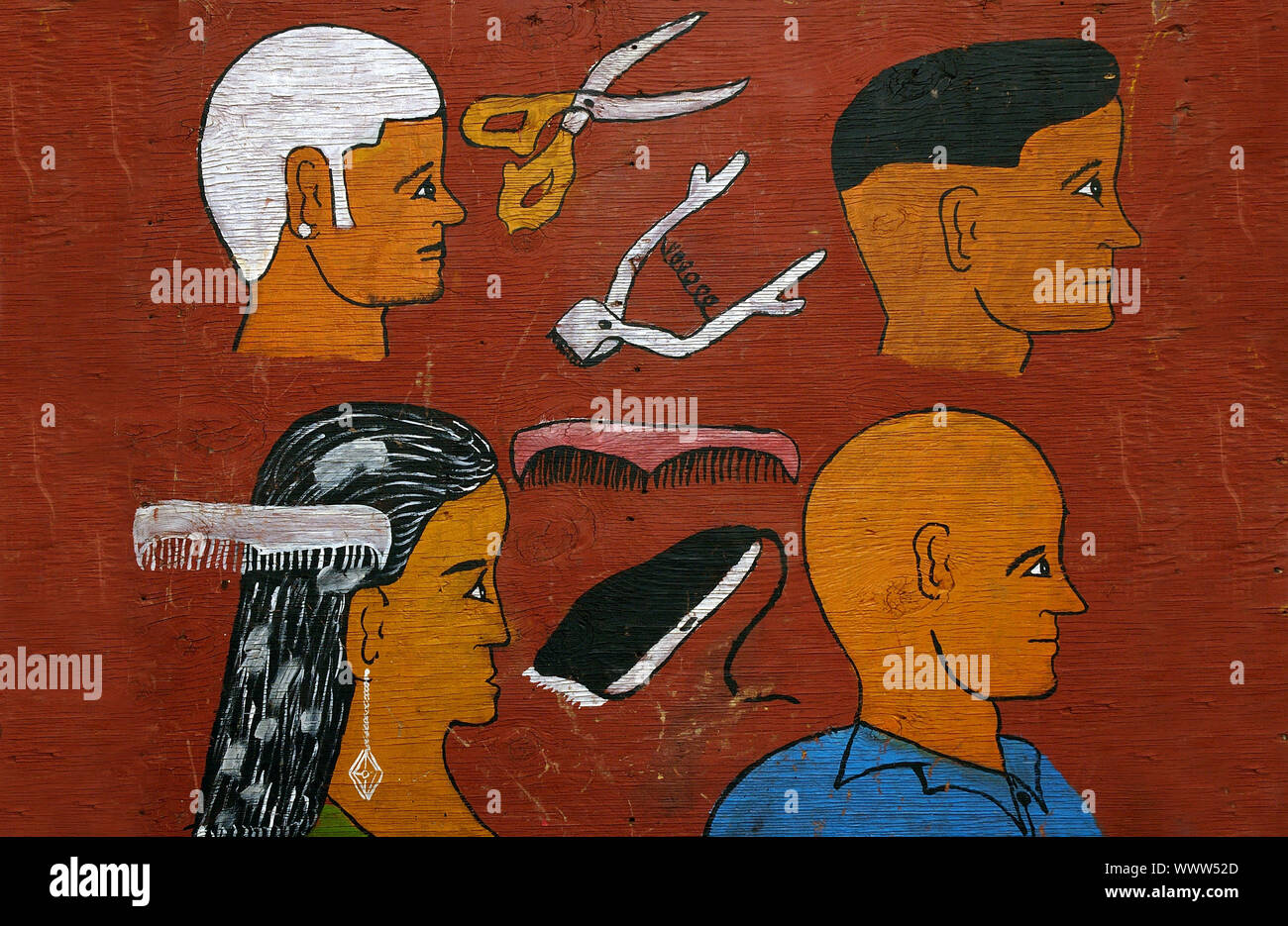A colorful, humorous painted signboard shows hairstyle proposals in a barbershop. Republic of Mali Western Africa. Many businesses use such paintings as a visual lingua franca to communicate what goods they sell Stock Photo