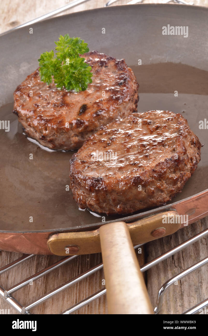 fried hamburger meat in a hot copper pan Stock Photo Alamy