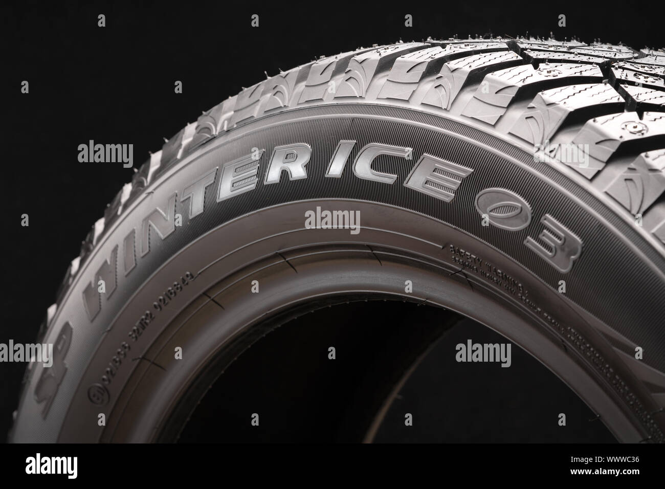 new winter studded tire Dunlop Winter Ice 03 on a black background ...
