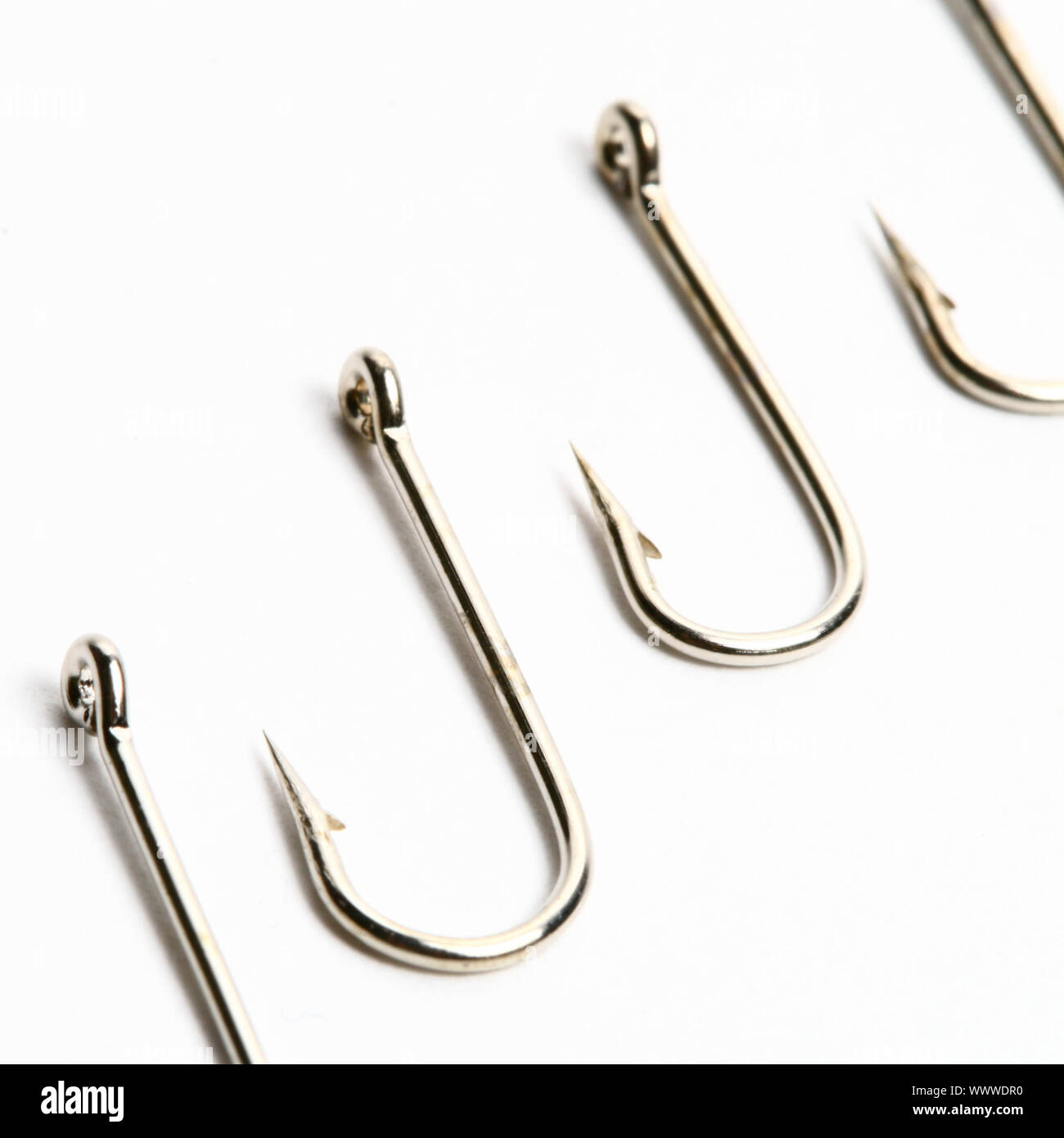 fishing hooks macro close up on white Stock Photo - Alamy