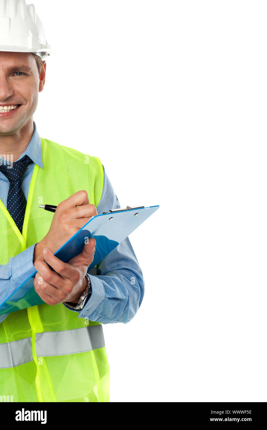 Cropped image of an architect engineer with clipboard and pen wearing helmet Stock Photo