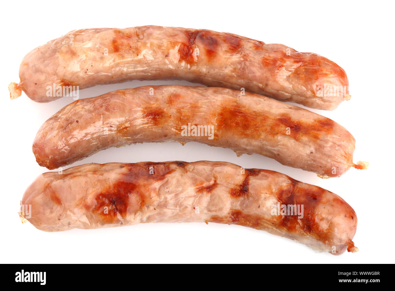three fried chipolata sausages on a white background Stock Photo Alamy