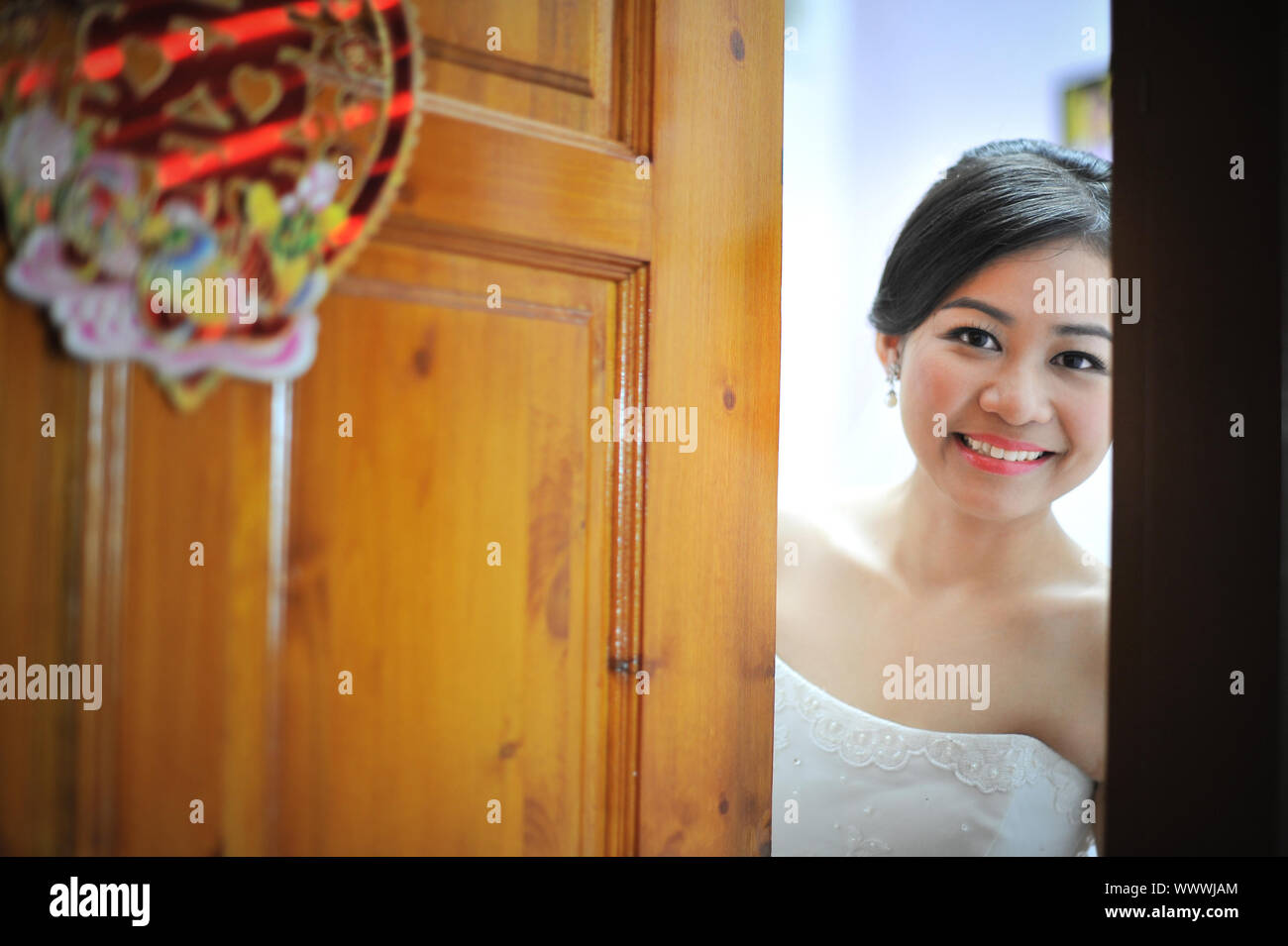 Beautiful bride open door for groom Stock Photo