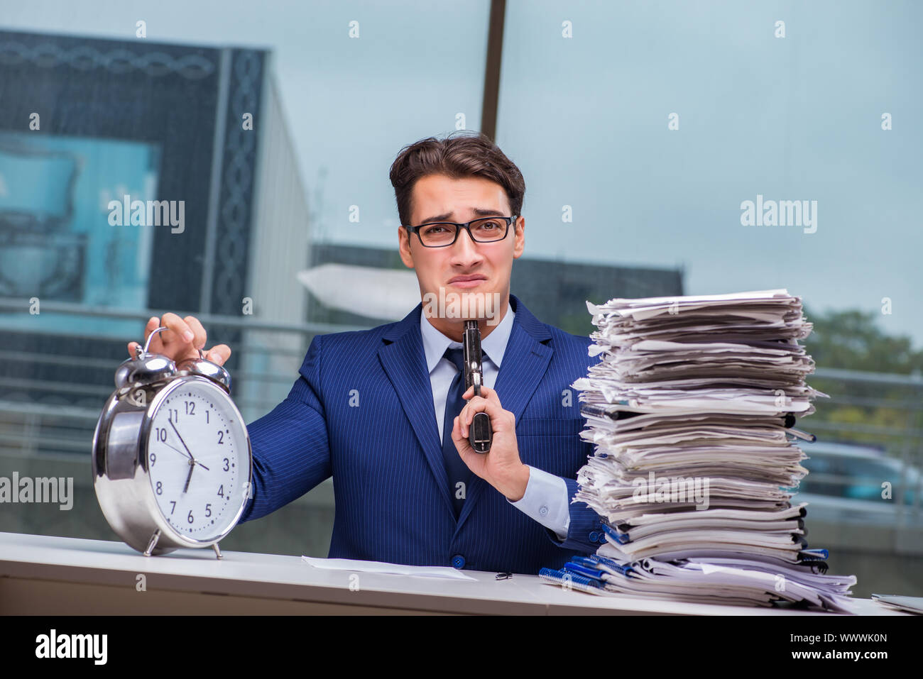Businessman With Pile Stack Of Paper Paperwork And An Alarm Cloc Stock Photo Alamy